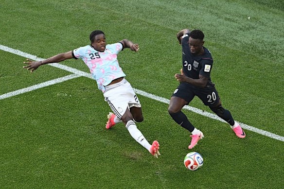 US World Cup star Folarin Balogun, right, and Belgium’s Nathan Ngoy contest the ball. The Americans lost and were eliminated from the tournament.