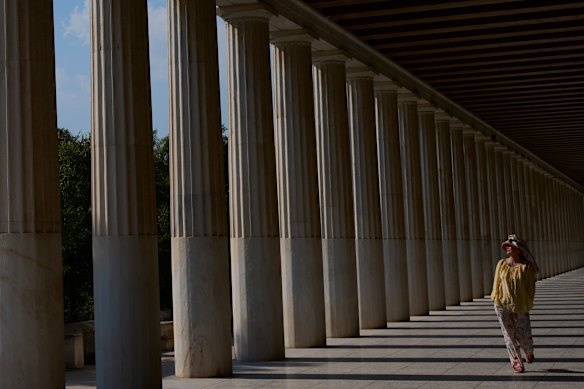 A tourist walks through the Stoa of Attalos at the Ancient Agora during a heat wave in Athens, Greece.