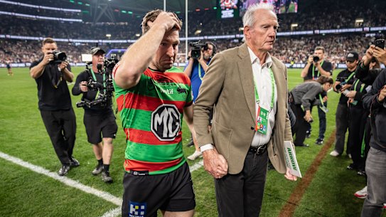 Coach Wayne Bennett accompanies Jai Arrow off the field after his 100th appearance for South Sydney.