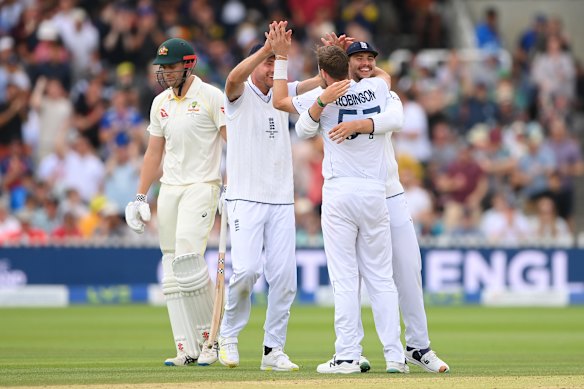 Ollie Robinson of England celebrates with teammates Stuart Broad and Josh Tongue after dismissing Cameron Green in the 2023 Ashes. 