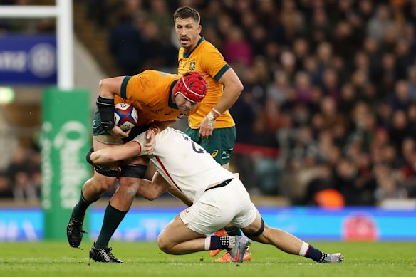 Harry Wilson is tackled at Twickenham.