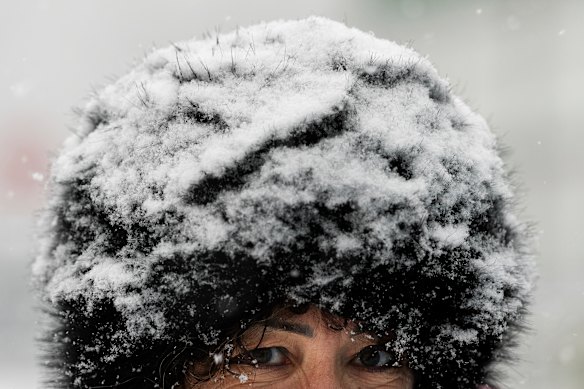 Snow settles on the hat of an attendee of an Olympic Village Cortina Media Day  in Italy.