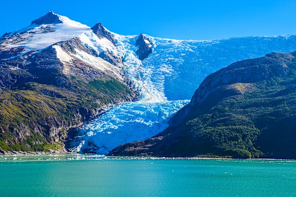 A glacier flows into a fjord along the coast of southern Chile. 