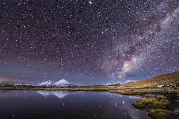 Cotacotani Lagoon reflecting the starry night sky in Lauca National Park, Chile.