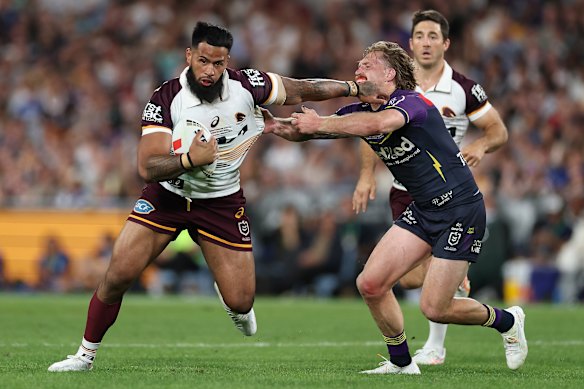 Payne Haas takes a charge for Brisbane.