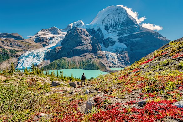 A hiker admires the view of Mount Robson Berg Lake in the Canadian Rockies of provincial British Columbia.
