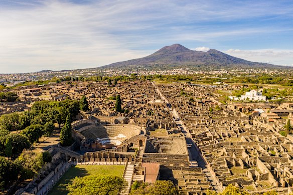 Pompeii with its destroyer, Mount Vesuvius, in the background.