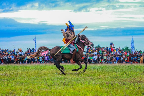 A traditional horseman  prepares to hurl a spear during Pasola, an annual harvest thanksgiving ritual in Sumba.