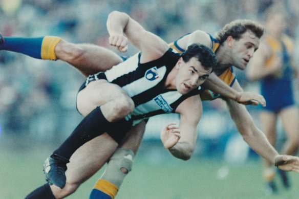 West Coast’s Paul Peos and Magpie Darren Millane battle it out in the 1990 qualifying final that ended in a draw.