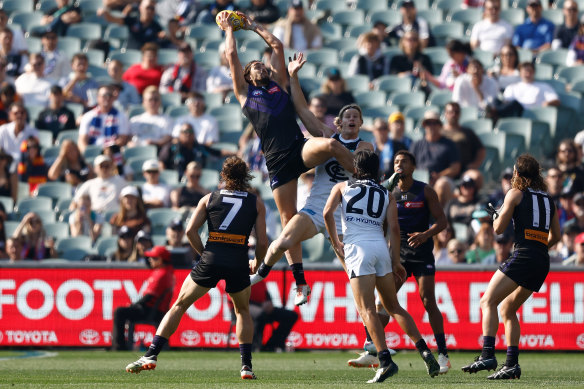 Luke Jackson of the Dockers takes a high mark over Tom De Koning of the Blues.