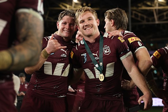 The Maroons celebrate their win.