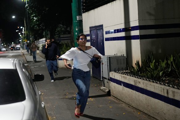 Pedestrians are seen running after explosions and low-flying aircraft were heard in Caracas