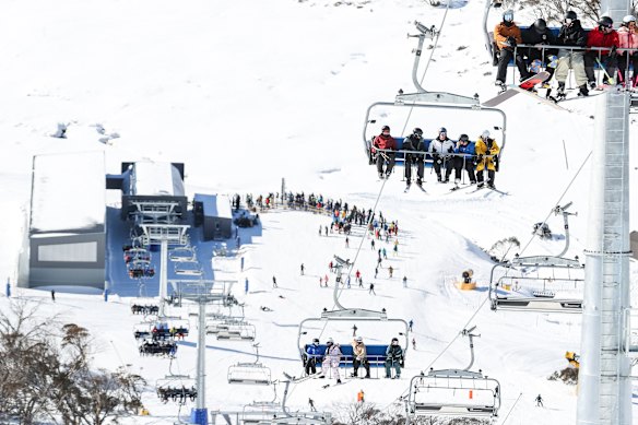 Skiers and snowboarders on the new chairlift at Mount Perisher in June.