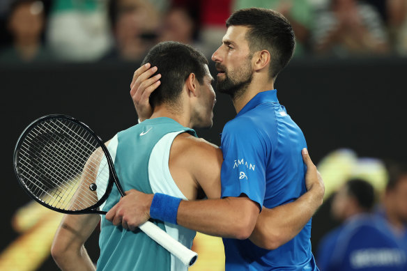 Novak Djokovic embraces Carlos Alcaraz after their quarter-final.