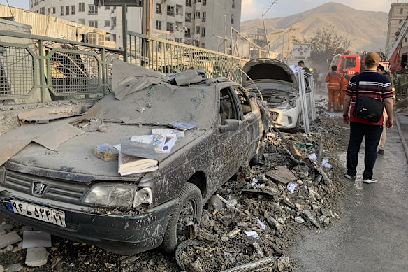 Damaged vehicles in the Iranian capital, Tehran, following an Israeli strike.