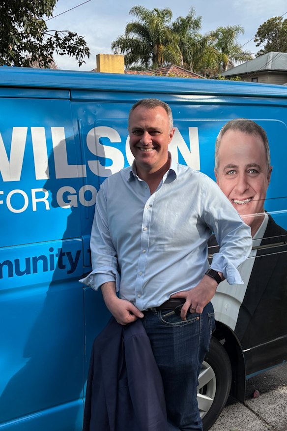 Wilson with his electric blue Toyota HiAce dubbed “Polly the Victory Van”, which doubles as a mobile advertising board.