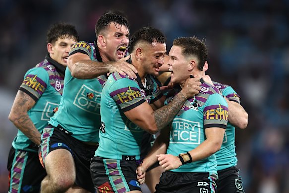 Titans NRL players celebrate after beating Wests Tigers in June.
