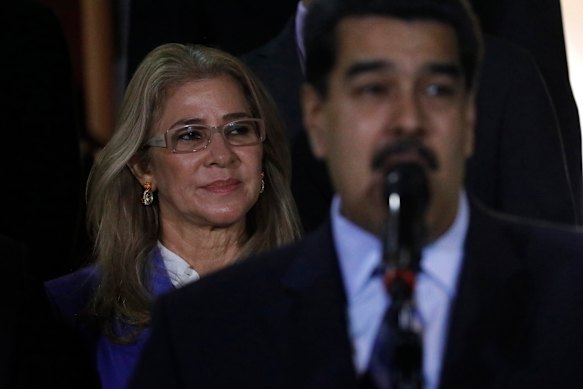 Venezuelan first lady Cilia Flores stands behind her husband Nicolas Maduro at a 2019 press conference at the Miraflores Palace.