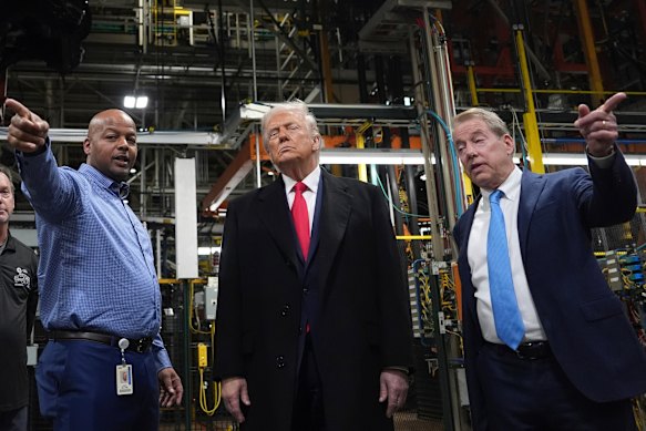 Donald Trump tours the Ford factory in Detroit with chairman Bill Ford (right) and plant manager Corey Williams (left).