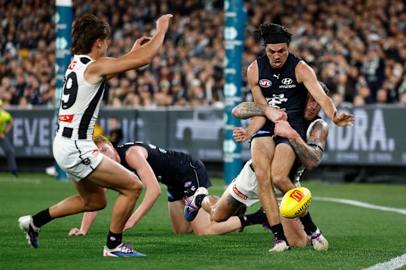 Elijah Hollands is tackled as he looks to get his kick away. He finished the match against Collingwood with just one disposal.