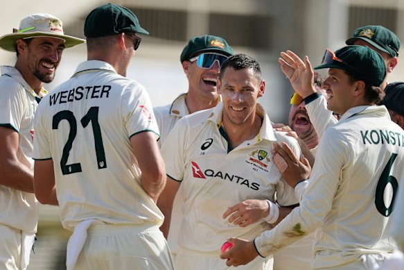 Scott Boland is mobbed by team-mates after his hat-trick.