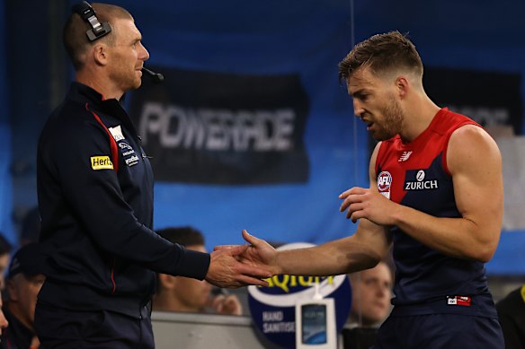 Simon Goodwin and Jack Viney share a moment on the boundary during the 2021 grand final.