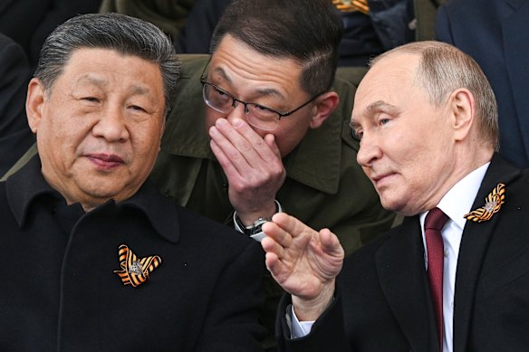 Vladimir Putin speaks to China’s President Xi Jinping during the Victory Day parade in Moscow.