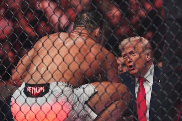 Trump talks to UFC fighter Paulo Costa at UFC 327 in Miami last month.