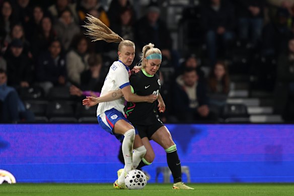 Ellie Carpenter of Australia is challenged by Aggie Beever-Jones of England during the Women’s International Friendly match between England and Australia at Pride Park  in Derby, England. 