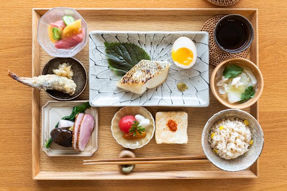 The Japanese breakfast set includes grilled fish, rice, soup, something fried, something grilled, a little sashimi and pickles.