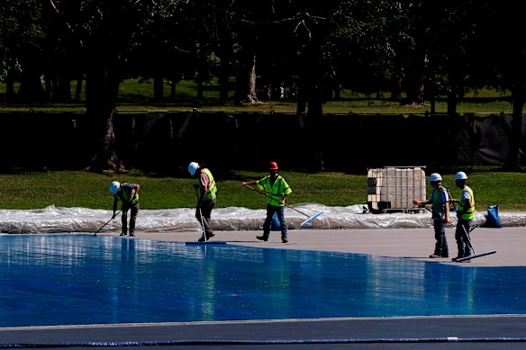 Workers apply a blue protective coating as part of a renovation project to the Lincoln Memorial Reflecting Pool, 