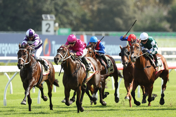 Fangirl (pink colours), winning the Apollo Stakes last year from Lindermann, left.