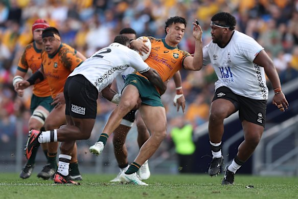 Joseph-Aukuso Suaalii of the Wallabies is tackled