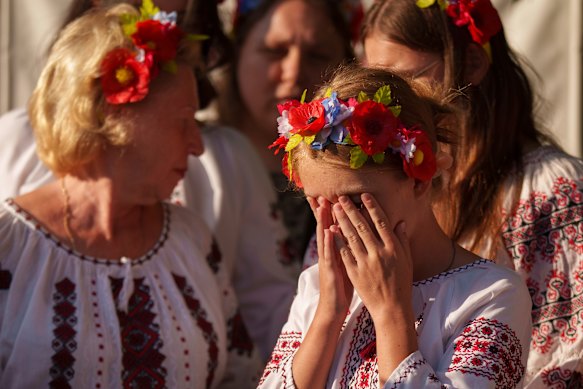 A member of a Ukrainian choir wipes her eyes before performing during an event held to show solidarity with Ukraine in Bucharest, Romania, on Thursday.