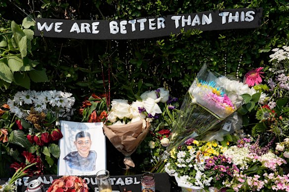 A portrait of Johan Sebastián Durán Guerrero, the man killed by U.S. Immigration and Customs Enforcement, is displayed among flowers and tributes at a makeshift memorial in Biddeford, Maine.
