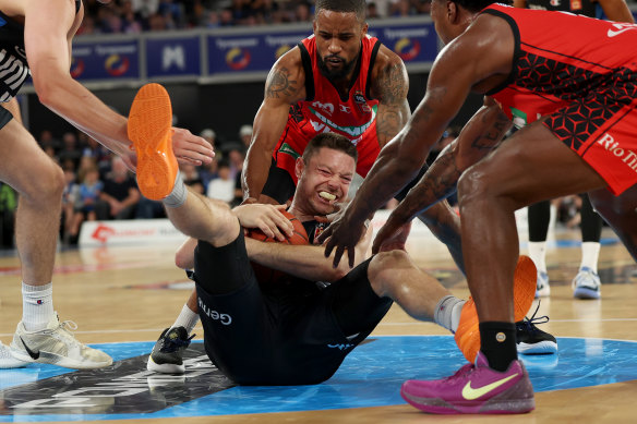 Matthew Dellavedova of United wrestles for the ball against Perth Wildcats.