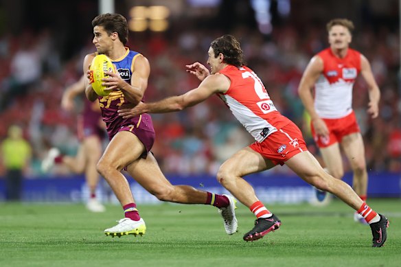 James Tunstill of the Lions is tackled by Errol Gulden of the Swans.
