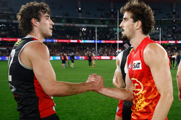 Max King of the Saints and bother Ben King of the Suns shake hands.