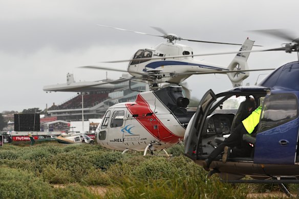 Helicopters en masse dropping off patrons at Flemington during race day.