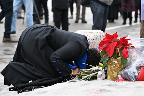 A mourner kneels at a makeshift memorial honouring Good in Minneapolis on Thursday.