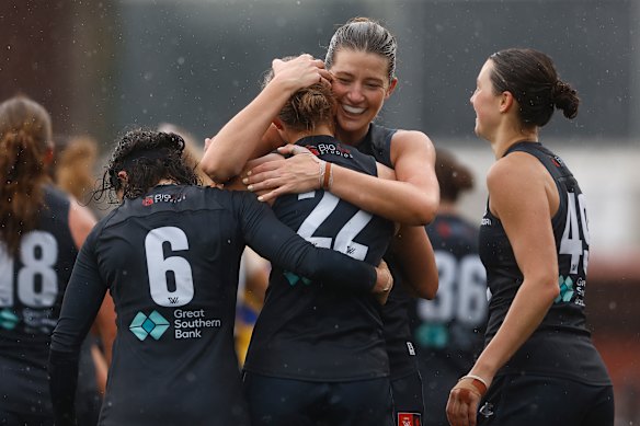 Jessica Good hugs her teammate Mia Austin (wearing No.22) after her emotional goal for Carlton.