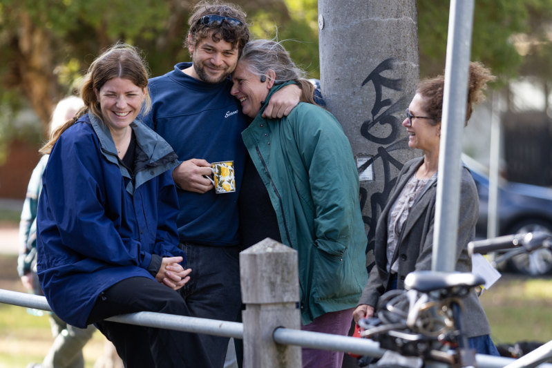 The buyer, in green, embracing a supporter on Saturday morning.