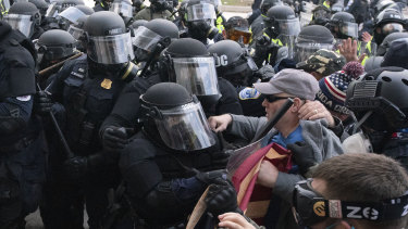 Capitol police officers in riot gear push back demonstrators trying to break a door of the US Capitol last week in Washington.