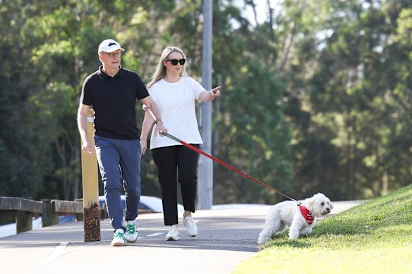 A walk in the park: Albanese with fiancee Jodie Haydon and dog Toto on Good Friday.