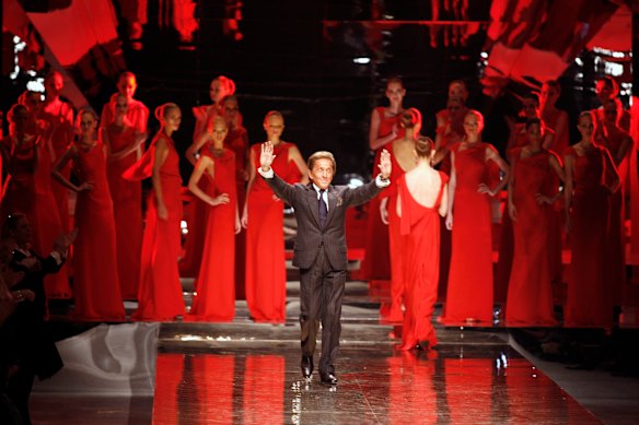 Italian fashion designer Valentino waves to the audience after the presentation of his Haute Couture Spring-Summer 2008 collection, in Paris.