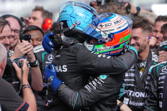 Russell (left) and Antonelli embrace.