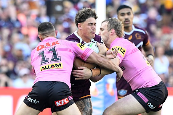 Reece Walsh is tackled.
