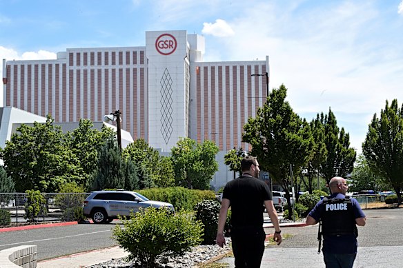 Police officers walk towards Reno’s Grand Sierra Resort after a shooting there on Monday.