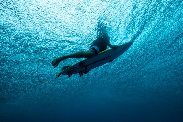 A surfer with an Ocean Guardian personal shark deterrent device.