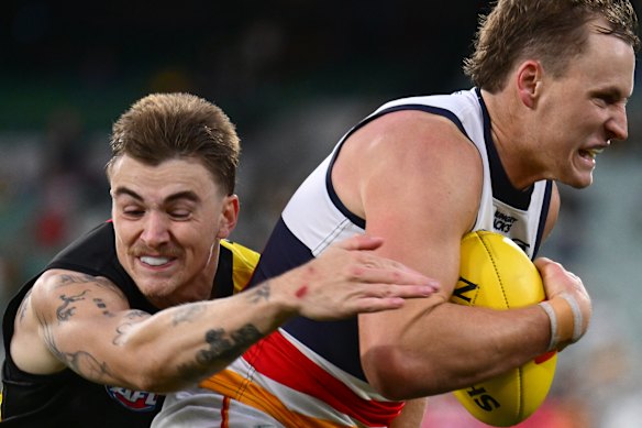 Crows star Jordan Dawson is tackled by Richmond’s Campbell Gray.